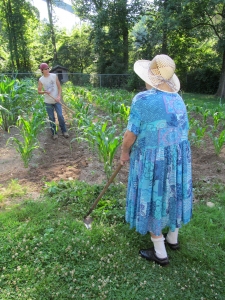 2011. An 80 year old woman tending a garden in shadow of a coal tipple.