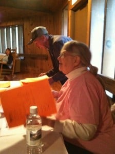 Grow Appalachia volunteer, Pat Yinger, accepts paperwork from new participants.