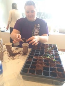 Kayla Whitt of the Mingo County Diabetes Coalition helps to plant seeds  