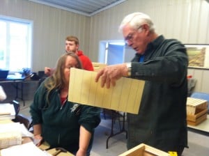 Allen instructing Gwen on assembling hive.