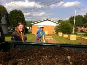 Hannah (left) and Laura (right) unloading compost into the raised beds at the Barbourville Community Garden. 