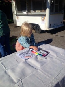 Eliza coloring and signing table cloth.