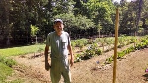 Mr. Sexton with his garden and fishing line fence.