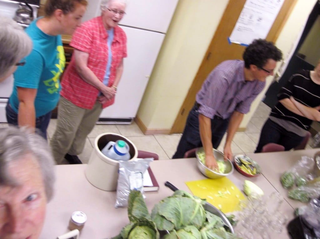 Rogers demonstrating the dry brine technique of massaging water out of the cabbage