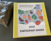 Photo of participant binder and a sample of garden soil.