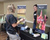 A Grow Appalachia member discussing plans for her farm with a vendor.