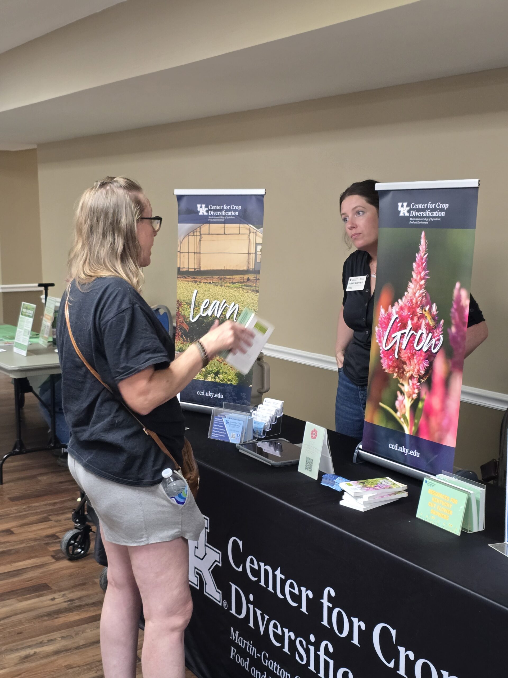 A Grow Appalachia member discussing plans for her farm with a vendor.