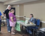A couple talks to a Grow Appalachia representative in this photo.