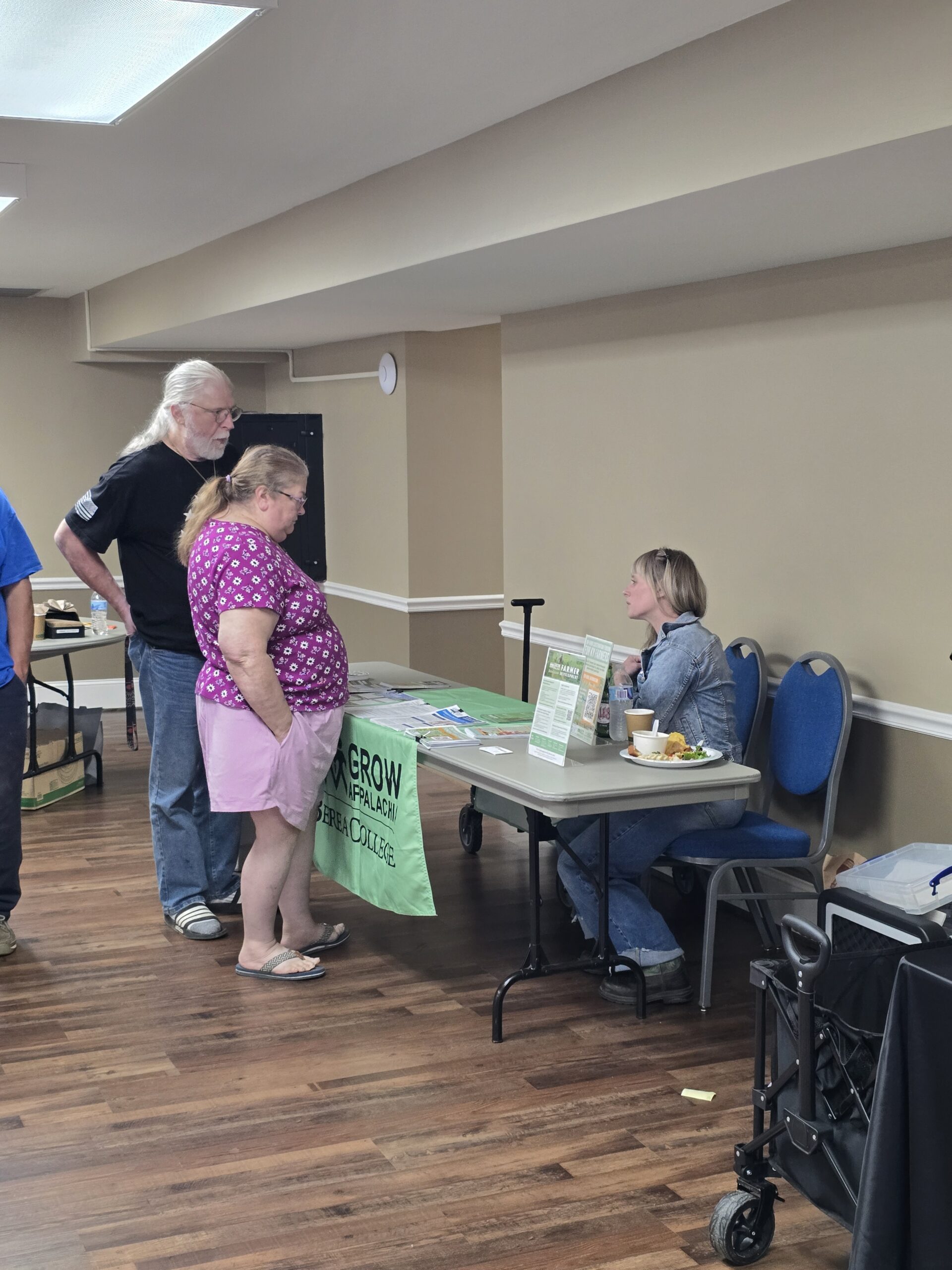 A couple talks to a Grow Appalachia representative in this photo.