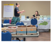 A younf man from KOAP discusses resources with the rep from the Kentucky Horticulture Council.